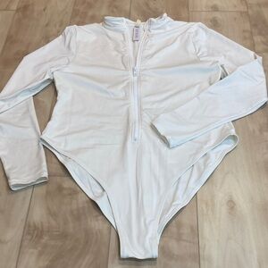 Skims “fits everybody” long sleeve full zip bodysuit